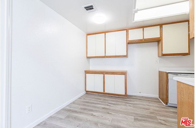 a view of an empty room with a window and fireplace