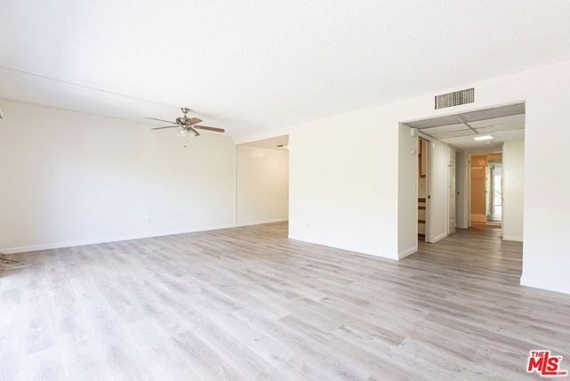 a view of a room with wooden floor