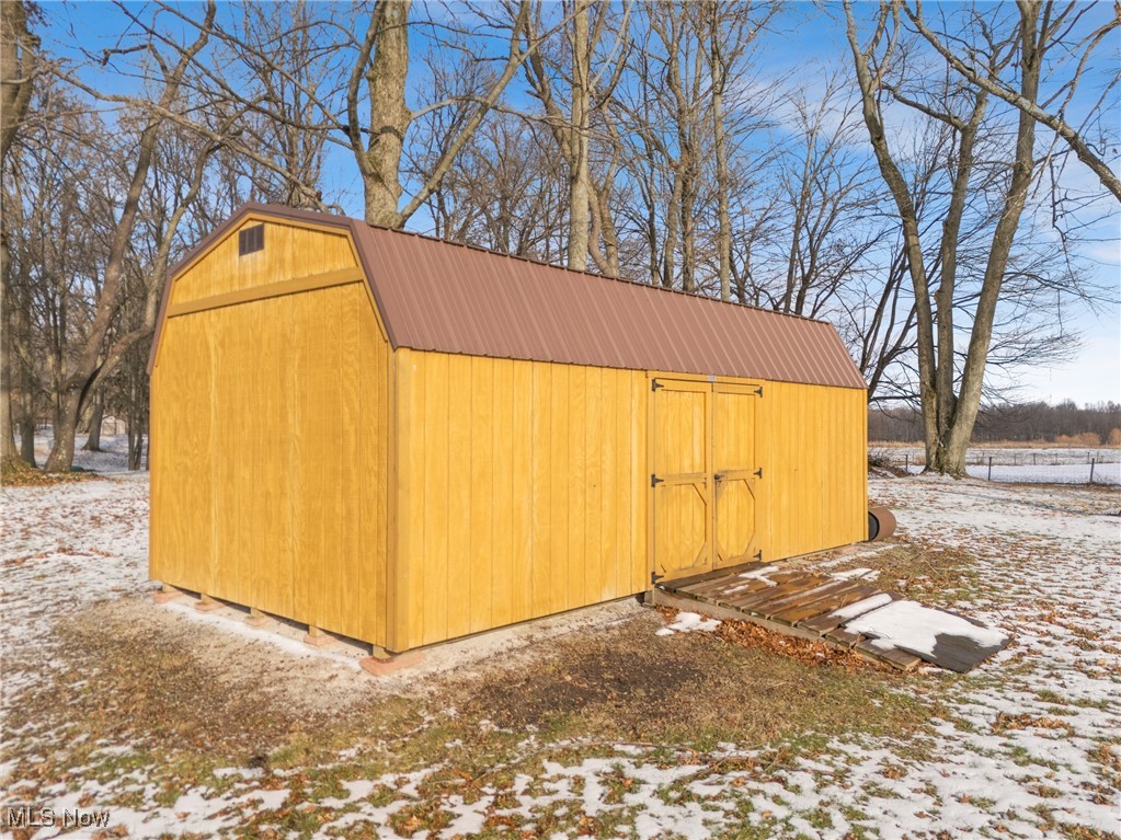 14965 Seacrist Road Salem, OH 44460 - Photo 28 of 43 Snow covered structure featuring a shed