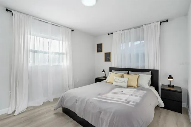 a bedroom with a bed and a window