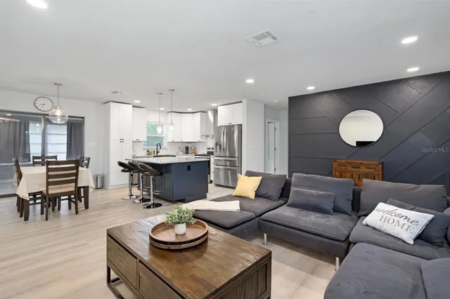 a living room with furniture kitchen and kitchen view