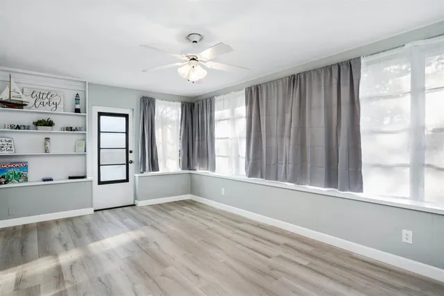 a view of an empty room with a window and closet
