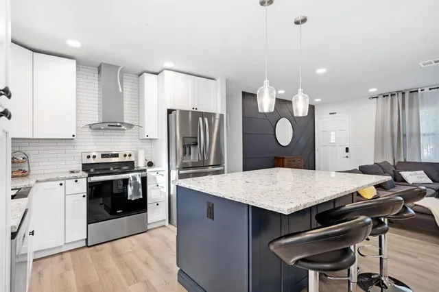 a kitchen with kitchen island cabinets and refrigerator