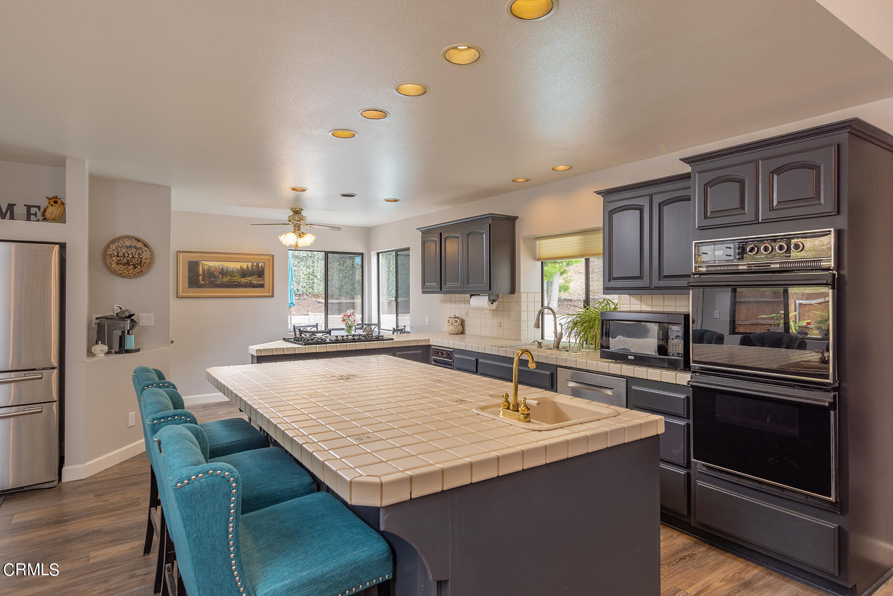 1131 Rancho Drive Ojai, CA 93023 - Photo 5 of 16 a dining table with kitchen island and stainless steel appliances