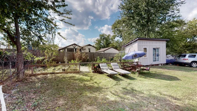 a view of a house with swimming pool and sitting area