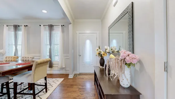 a dining room with furniture and flowers