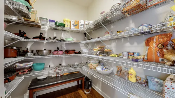 a kitchen with lots of clutter and cabinets
