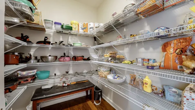 a kitchen with lots of clutter and cabinets