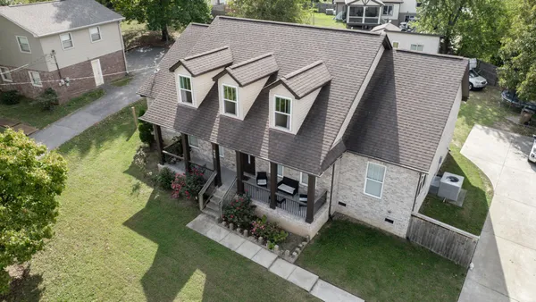 a aerial view of a house with a yard