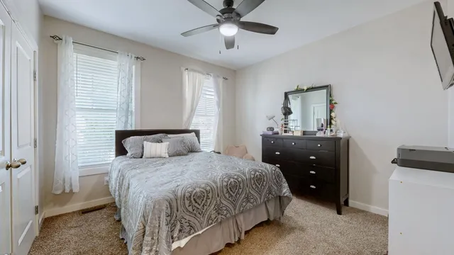 a bedroom with a bed and a chandelier