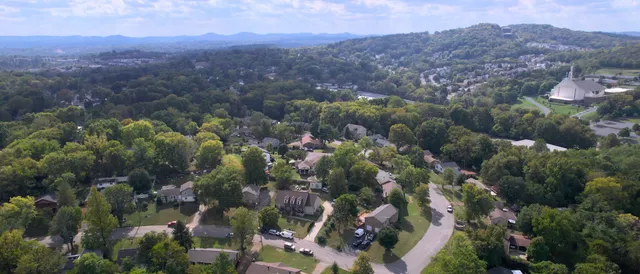 an aerial view of house with yard and mountain view
