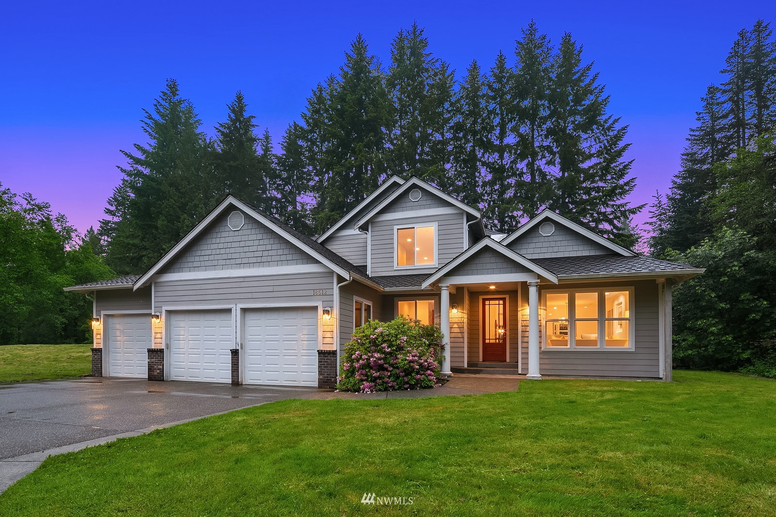 18512 Southeast Petrovitsky Road Renton, WA 98058 - Photo 1 of 40 a front view of a house with a yard and garage