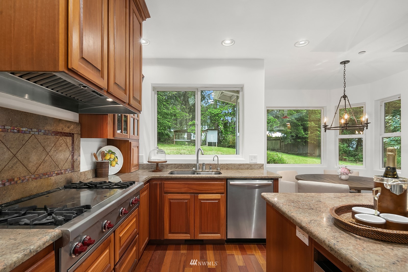 18512 Southeast Petrovitsky Road Renton, WA 98058 - Photo 15 of 40 a kitchen with stainless steel appliances granite countertop a sink a stove and a wooden floors