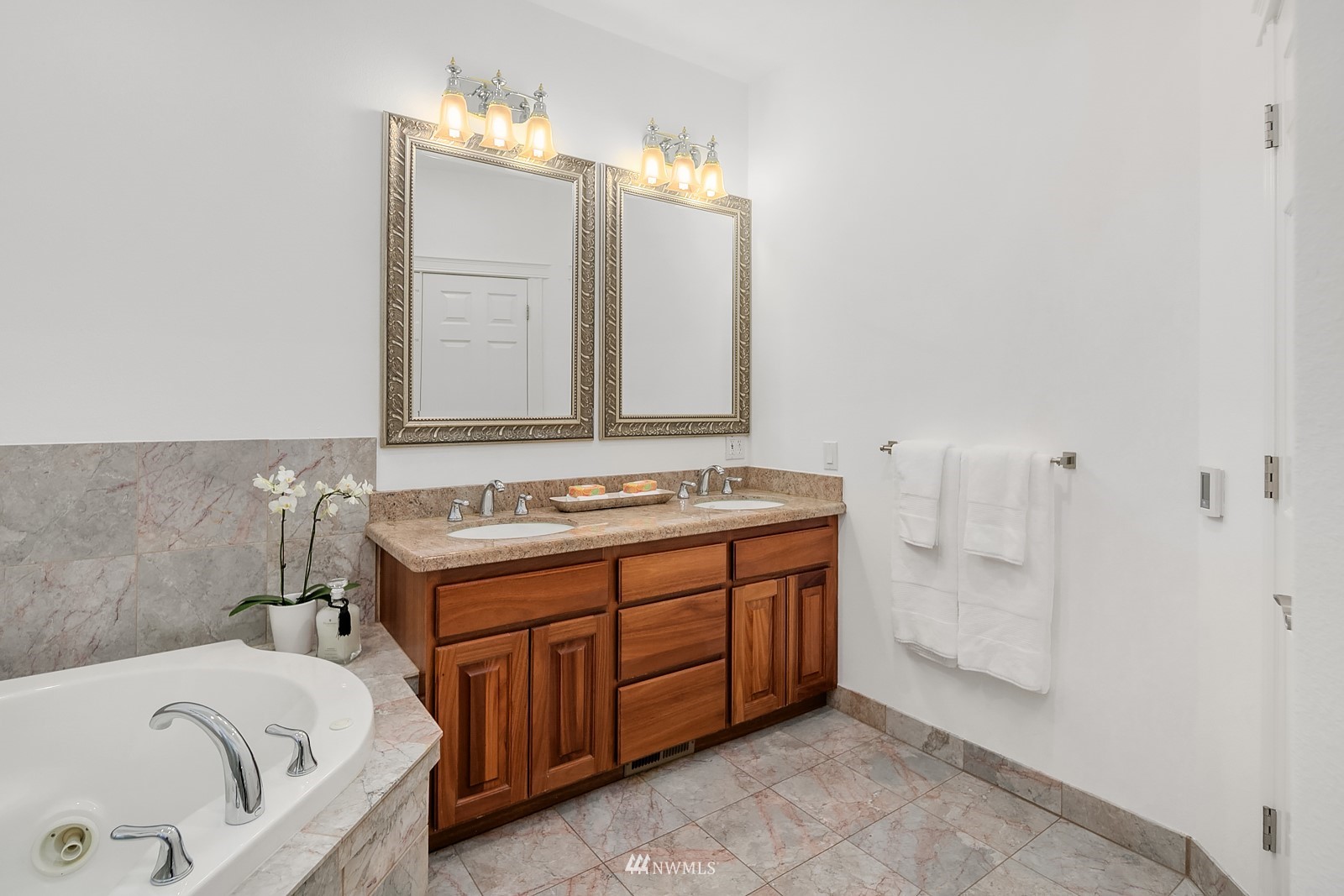 18512 Southeast Petrovitsky Road Renton, WA 98058 - Photo 19 of 40 a bathroom with a tub sink and mirror