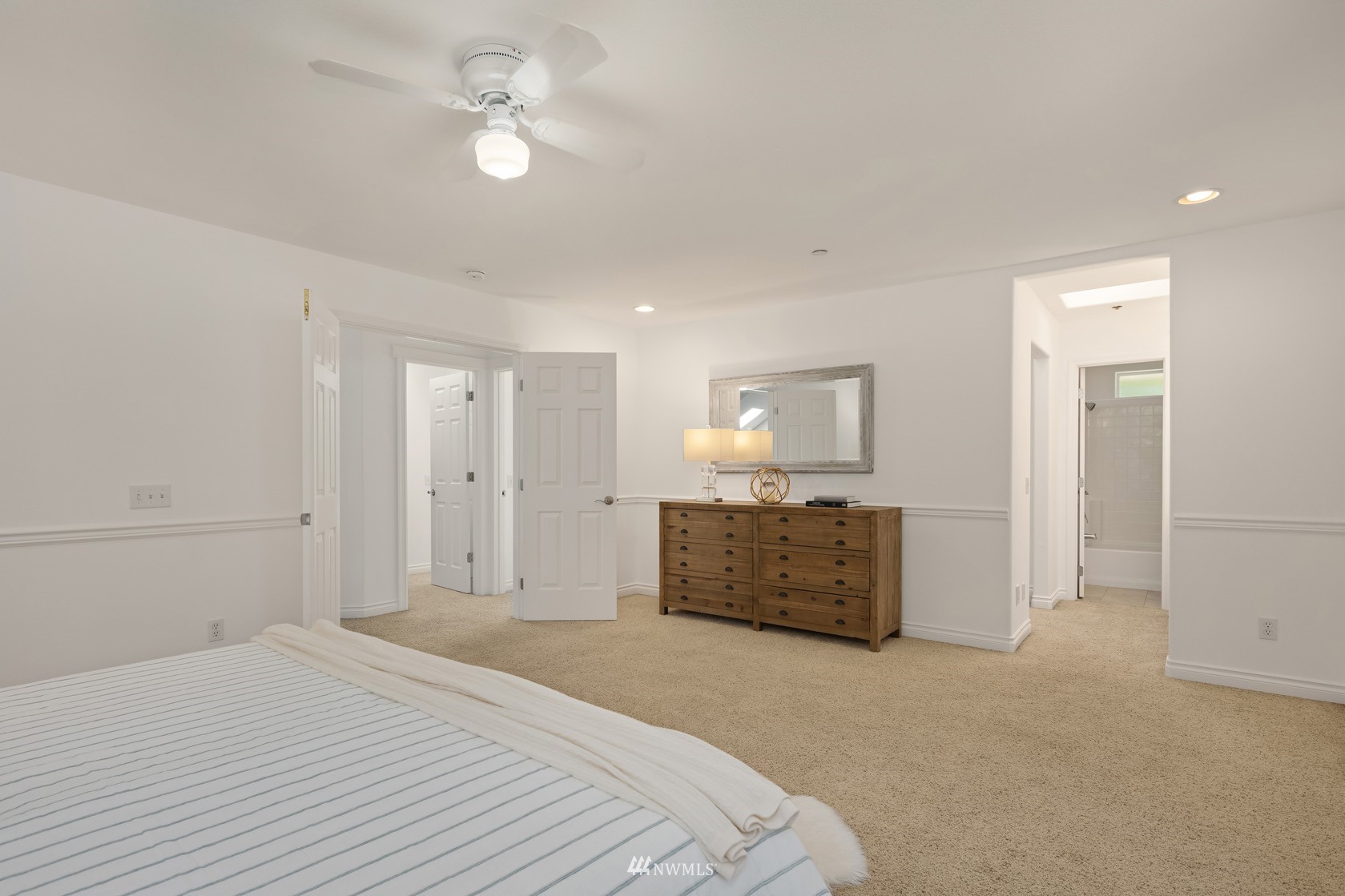 18512 Southeast Petrovitsky Road Renton, WA 98058 - Photo 25 of 40 a bedroom with a large bed a chandelier and closet