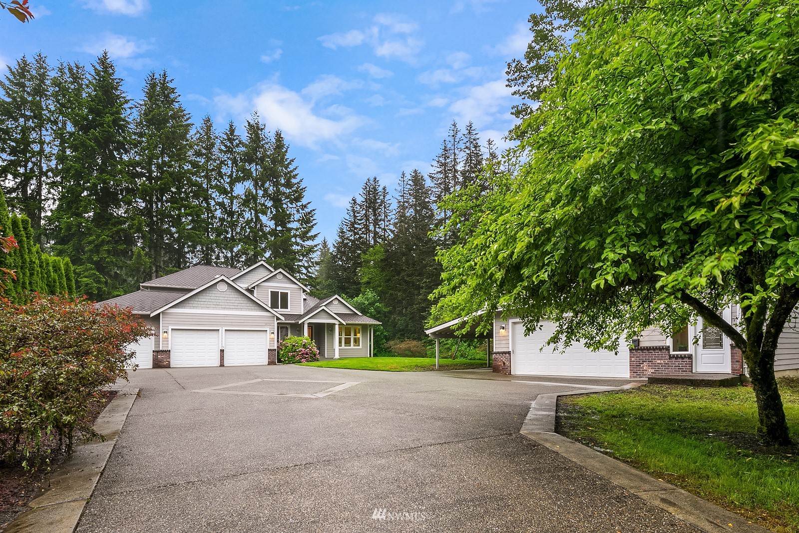 18512 Southeast Petrovitsky Road Renton, WA 98058 - Photo 30 of 40 a view of house with a yard and large trees