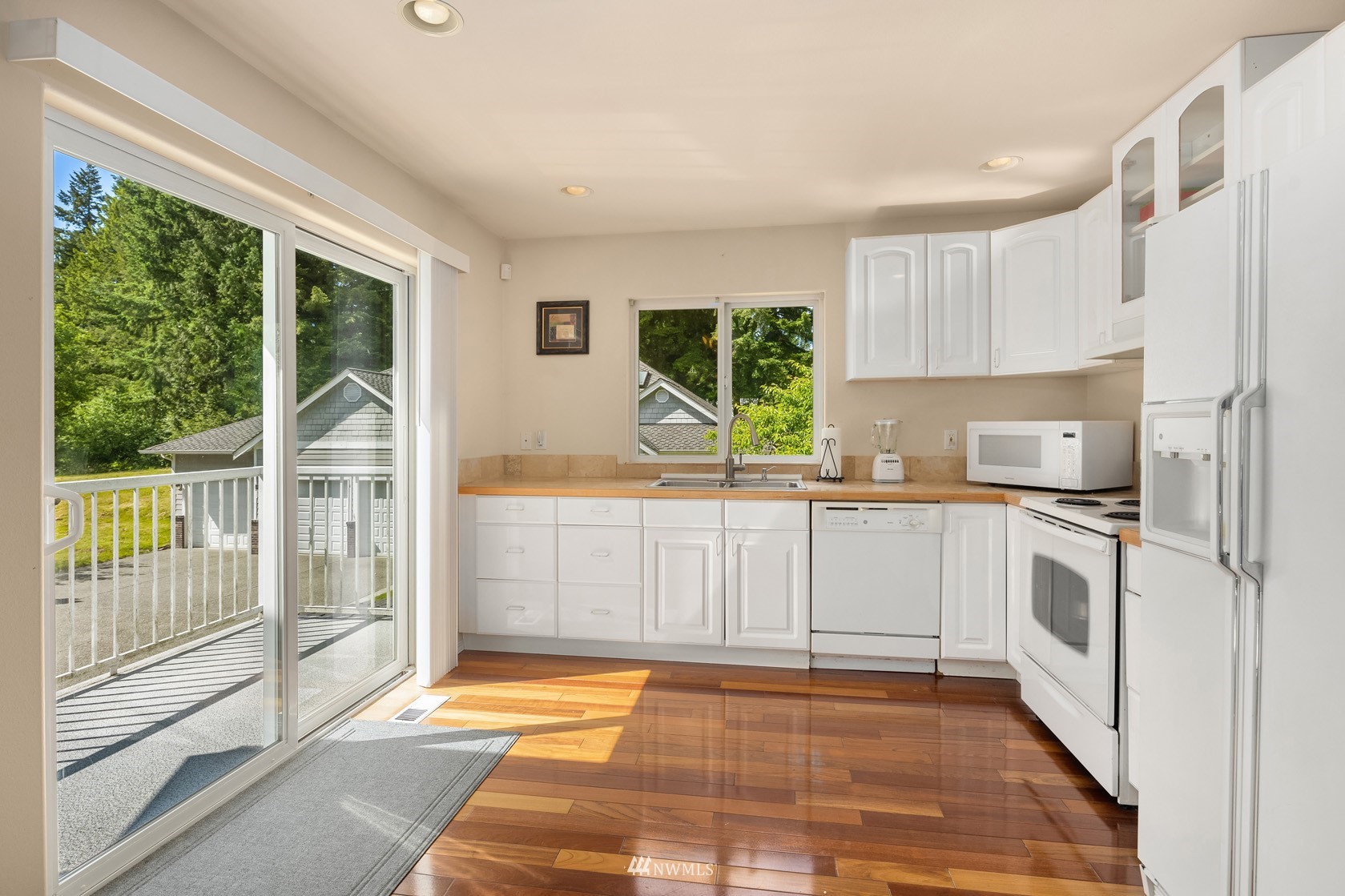 18512 Southeast Petrovitsky Road Renton, WA 98058 - Photo 37 of 40 a kitchen with stainless steel appliances granite countertop a stove a sink and a refrigerator
