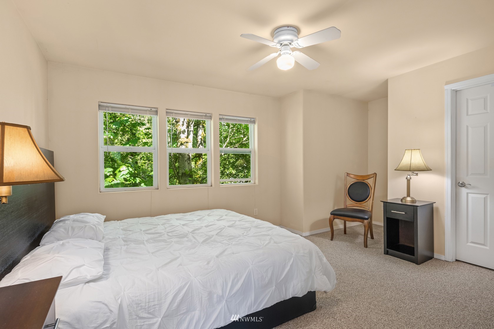 18512 Southeast Petrovitsky Road Renton, WA 98058 - Photo 40 of 40 a bedroom with a large bed and a chandelier