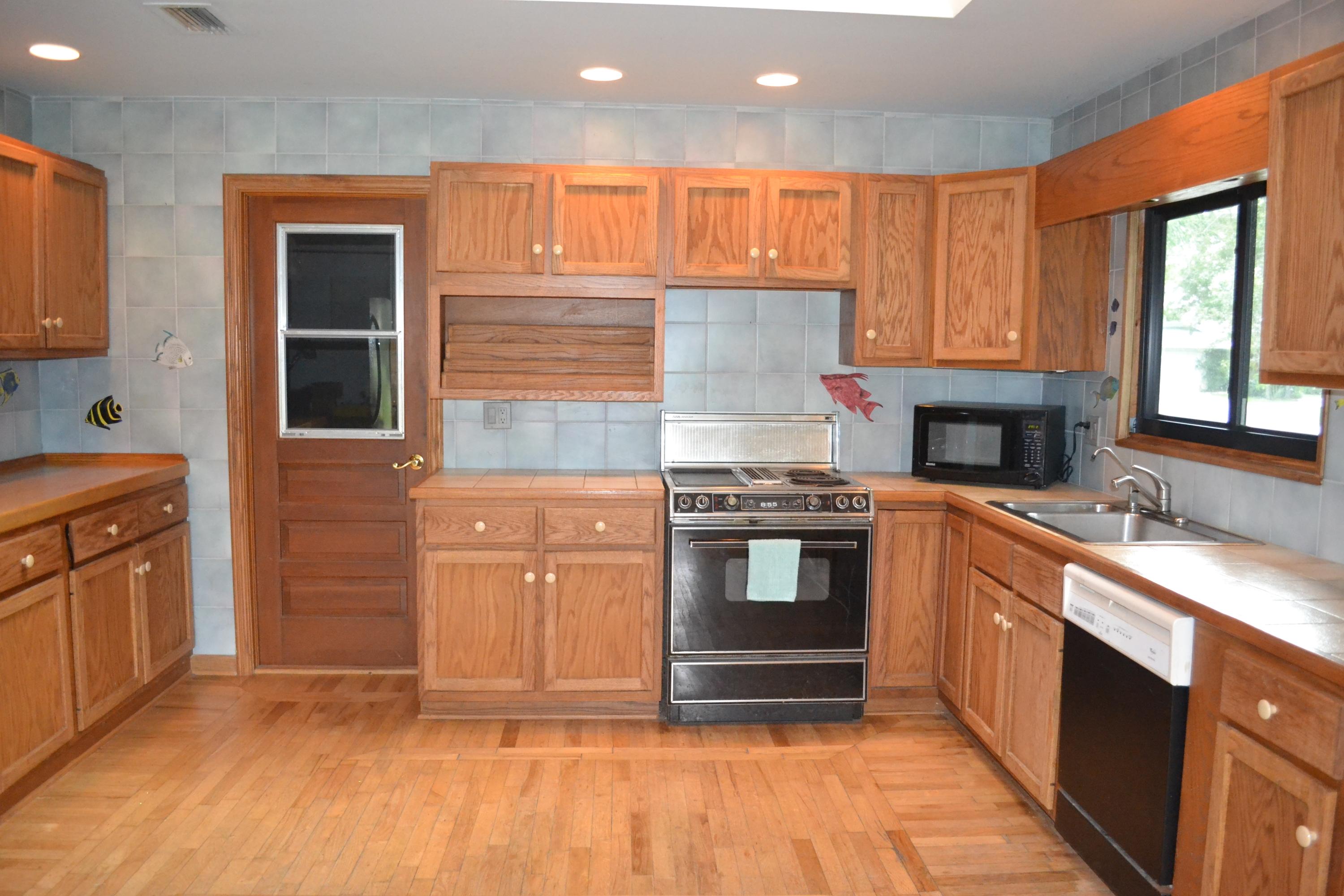 6063 Wood Lake Road Jupiter, FL 33458 - Photo 20 of 60 WOOD KITCHEN CABINETS AND FLOOR
