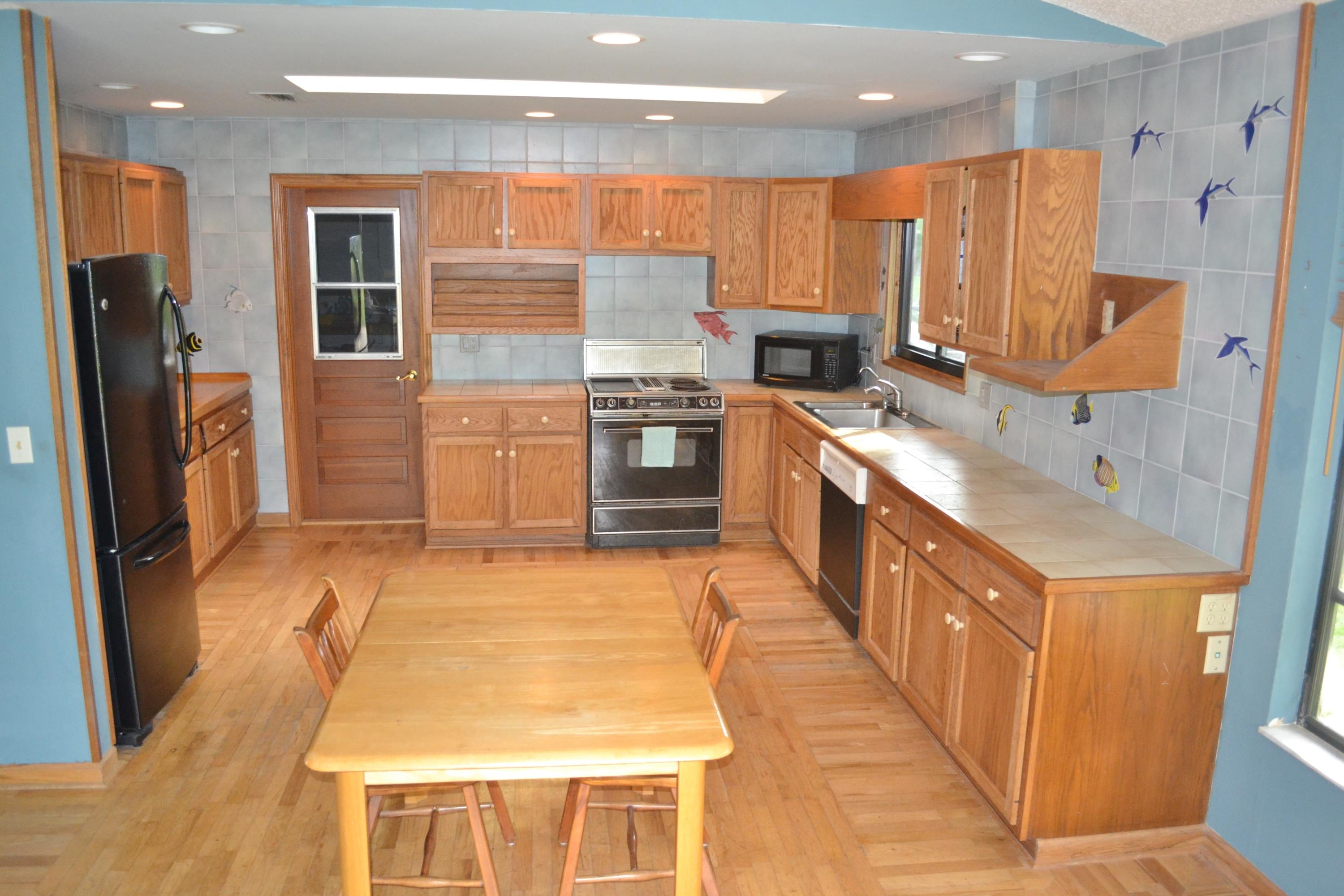 6063 Wood Lake Road Jupiter, FL 33458 - Photo 25 of 60 BACK DOOR TO GARAGE FROM KITCHEN