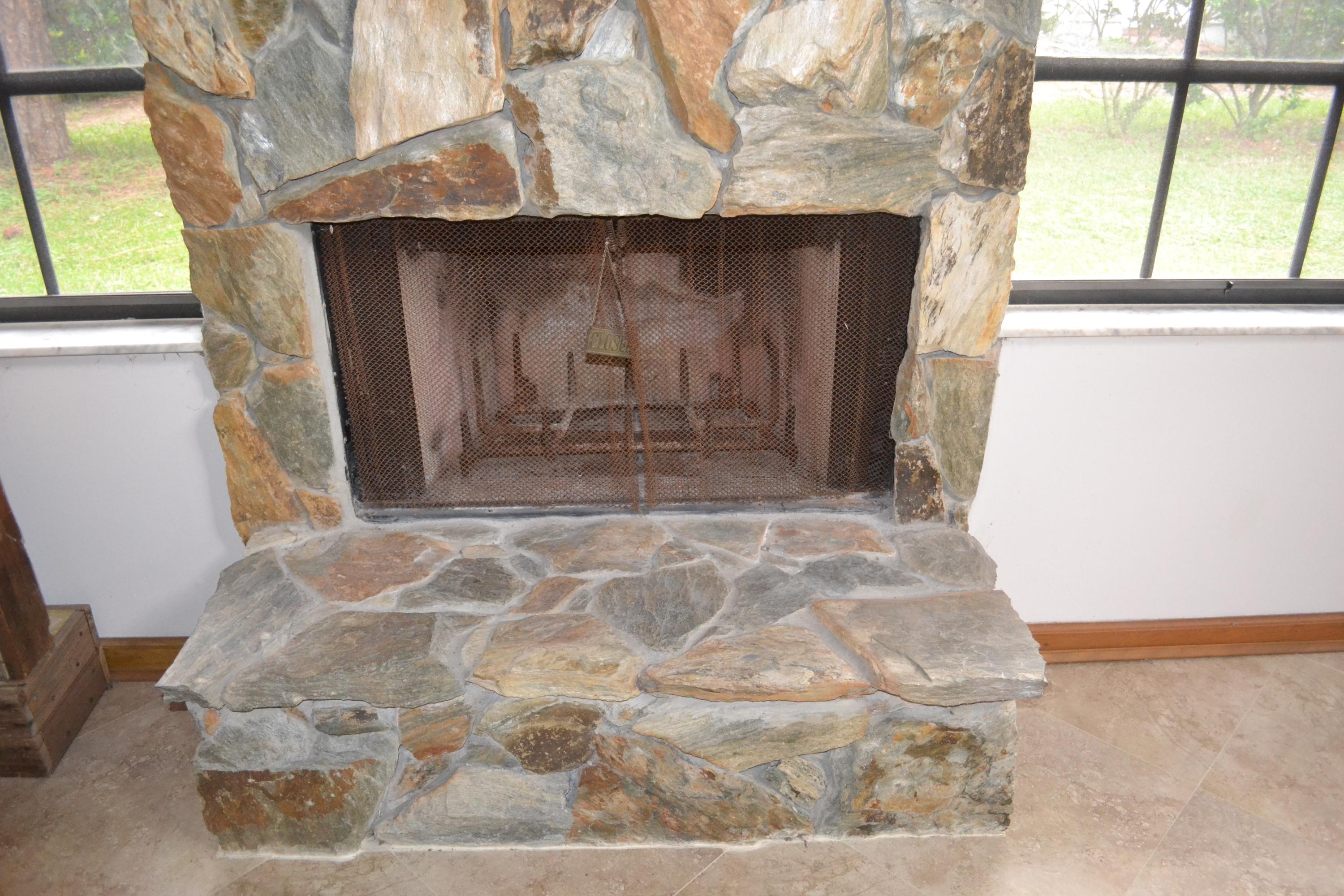 6063 Wood Lake Road Jupiter, FL 33458 - Photo 28 of 60 STONE FACED FIREPLACE FLOOR TO CEILING