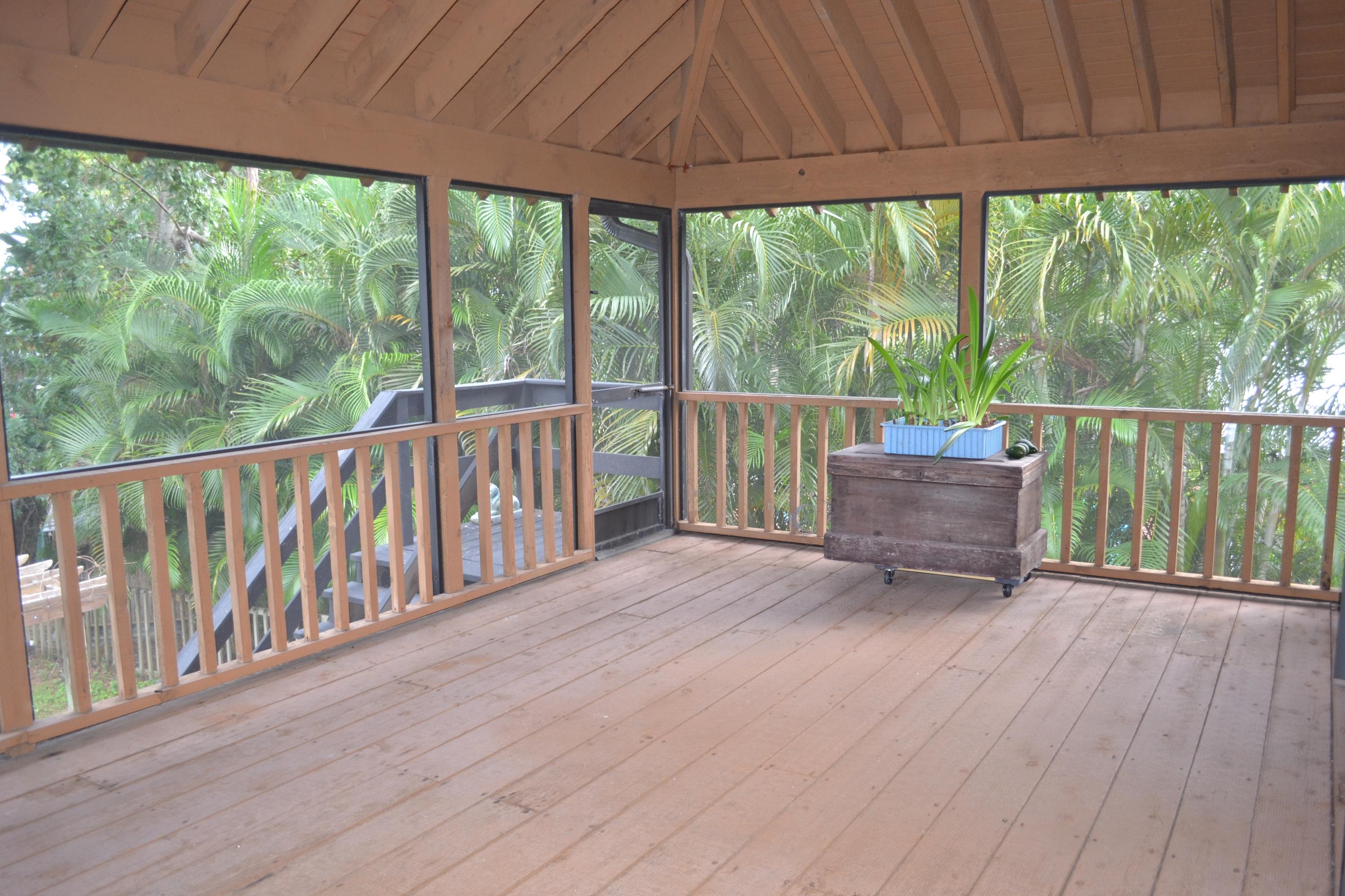 6063 Wood Lake Road Jupiter, FL 33458 - Photo 44 of 60 SCREENED PORCH HAS STAIRS TO YARD