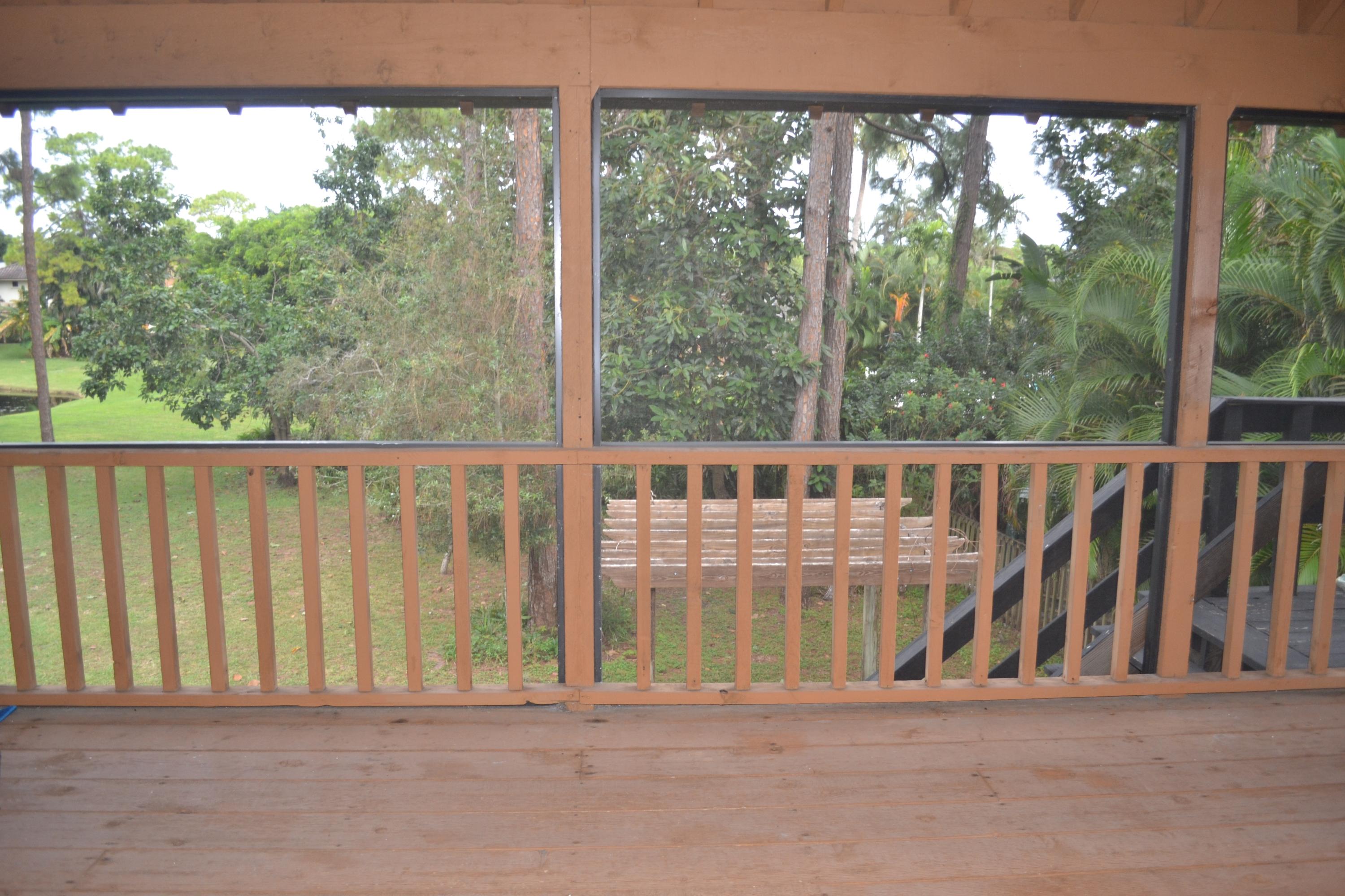 6063 Wood Lake Road Jupiter, FL 33458 - Photo 47 of 60 VIEW OF BACK YARD TREES FROM PORCH