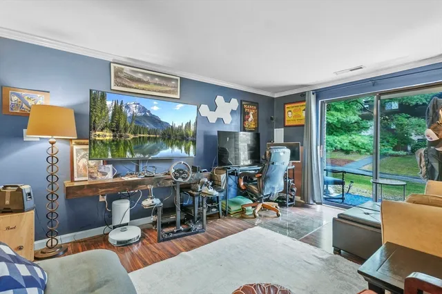 a view of a livingroom with workspace and a window