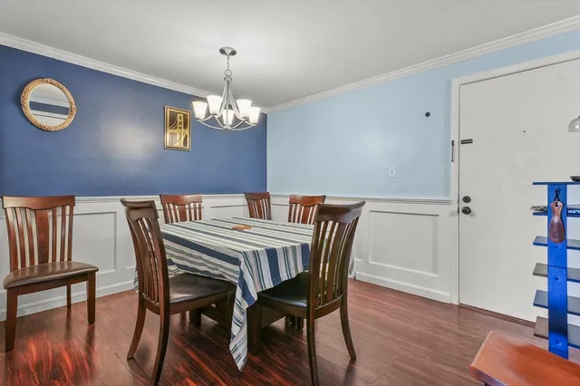a view of a dining room with furniture wooden floor and chandelier