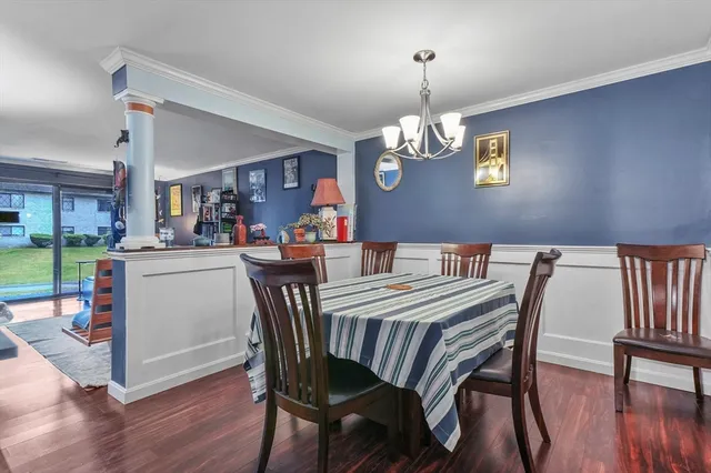 a view of a dining room with furniture wooden floor and chandelier