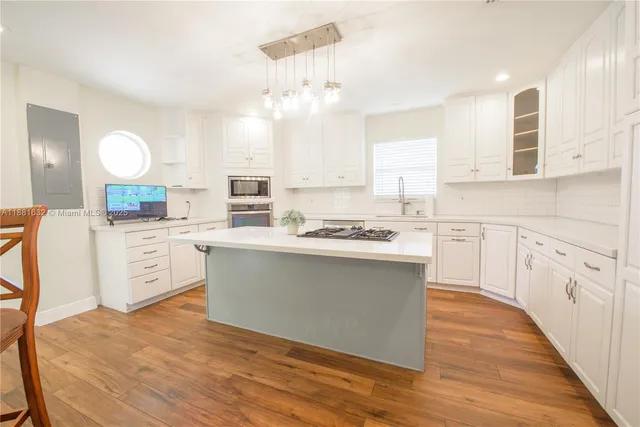 a kitchen with a white cabinets stove and sink