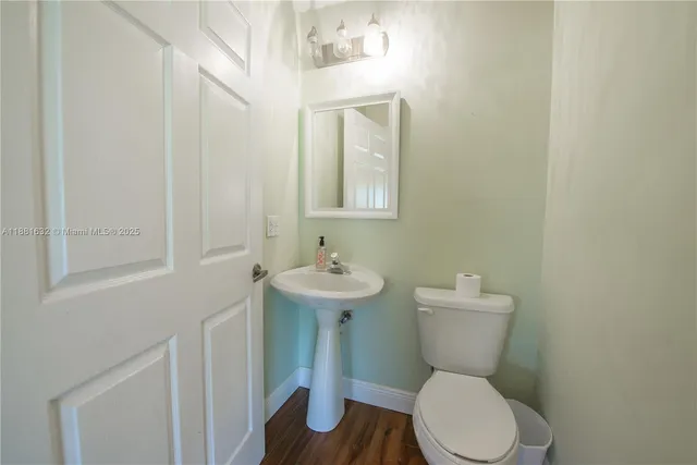a white toilet sitting next to a bathroom sink