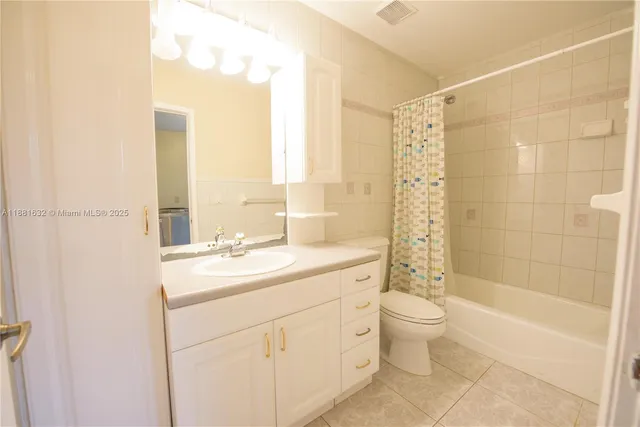 a bathroom with a double vanity sink toilet and shower