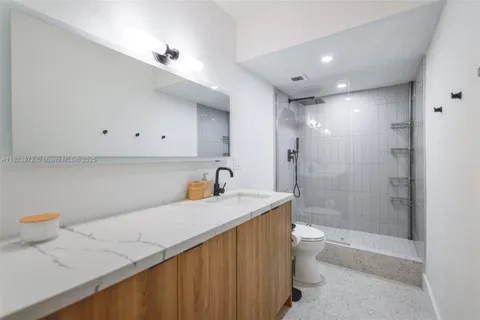 a bathroom with a shower a toilet and a sink