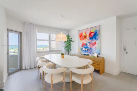 a dining room with furniture and window