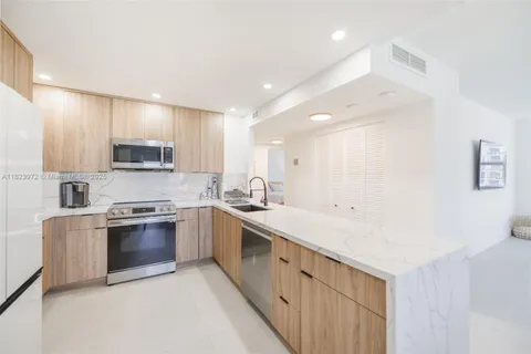 a kitchen with stainless steel appliances granite countertop a sink and stove top oven