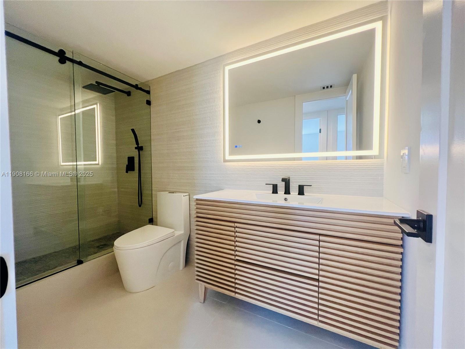 201 Jefferson Avenue, Unit 4C Miami Beach, FL 33139 - Photo 4 of 13 a white and white bathroom with a sink