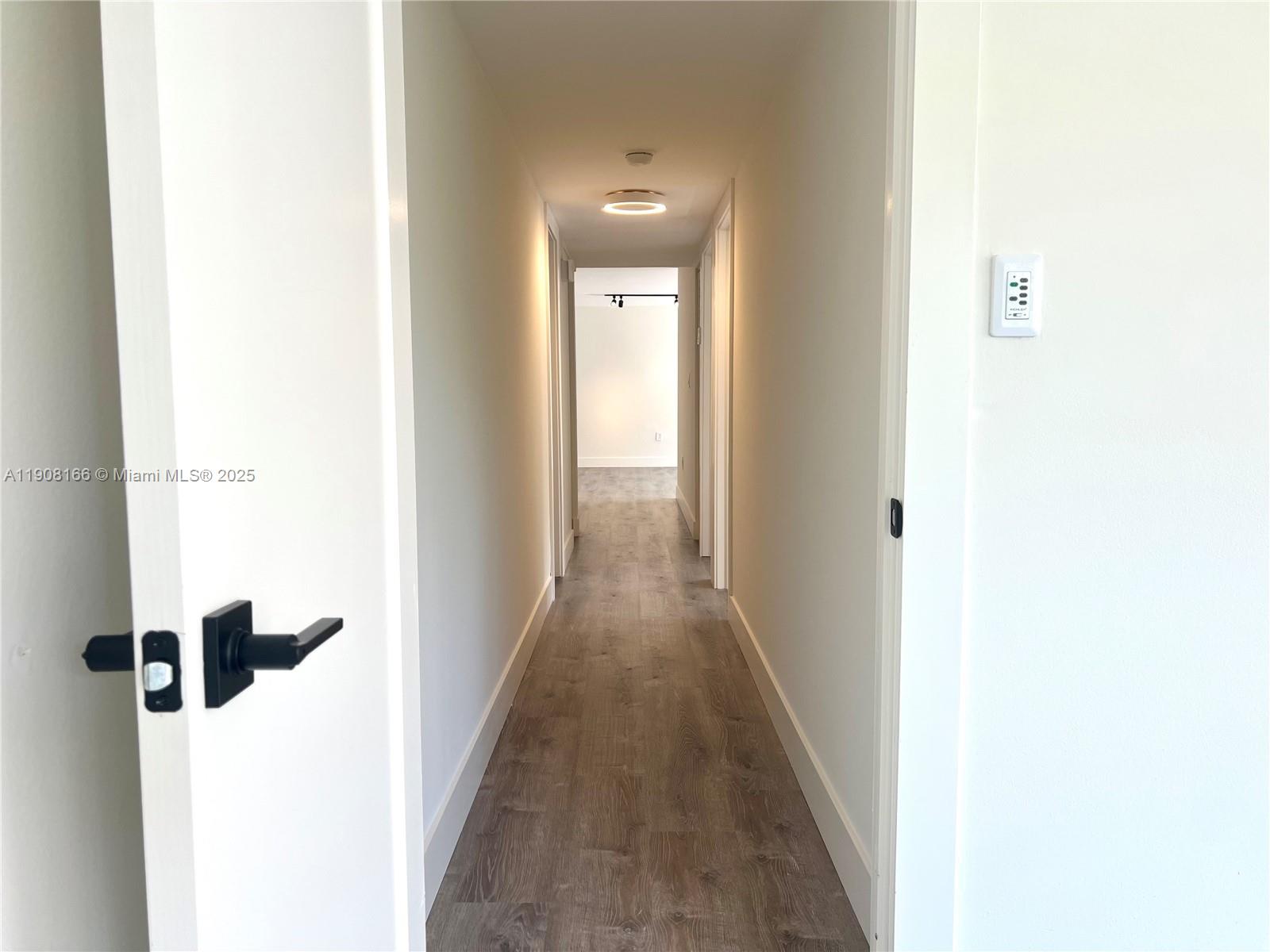 201 Jefferson Avenue, Unit 4C Miami Beach, FL 33139 - Photo 7 of 13 a view of a hallway with wooden floor