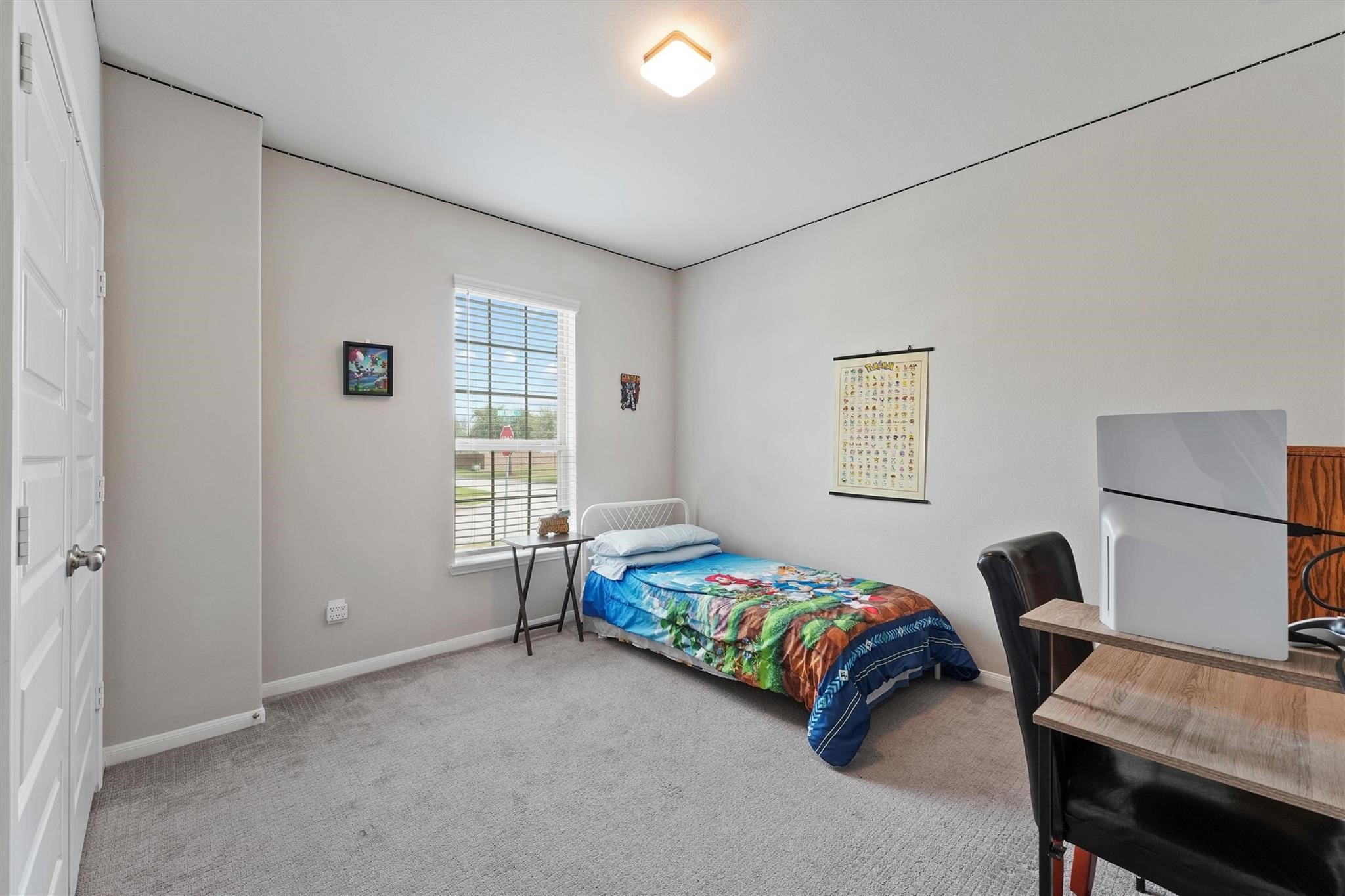 15103 Dry Ridge Court Humble, TX 77346 - Photo 11 of 28 a bedroom with a bed a desk and chair