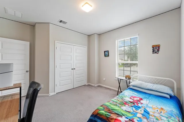 a bedroom with furniture and a window