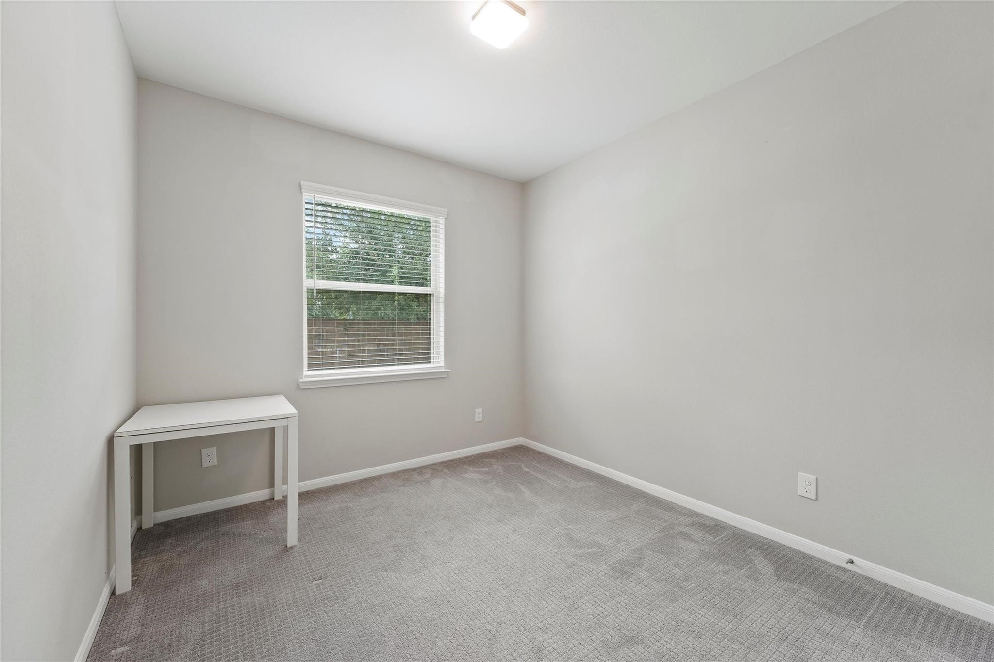 15103 Dry Ridge Court Humble, TX 77346 - Photo 14 of 28 an empty room with a window