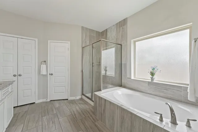 a spacious bathroom with a granite countertop sink and a mirror