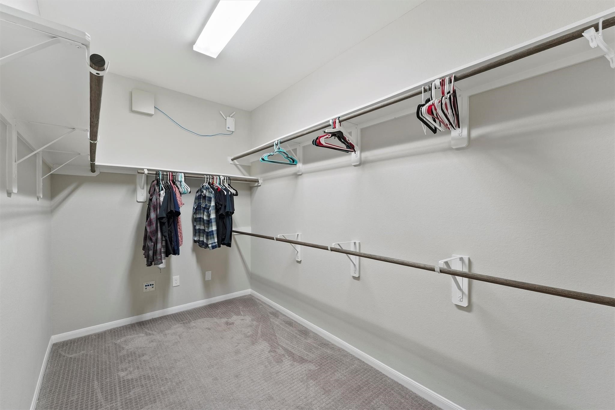 15103 Dry Ridge Court Humble, TX 77346 - Photo 19 of 28 a view of walk in closet with clothes and shoes