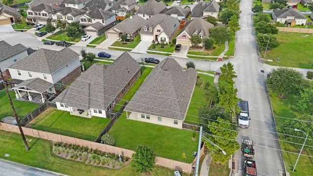 an aerial view of a house with a garden and trees
