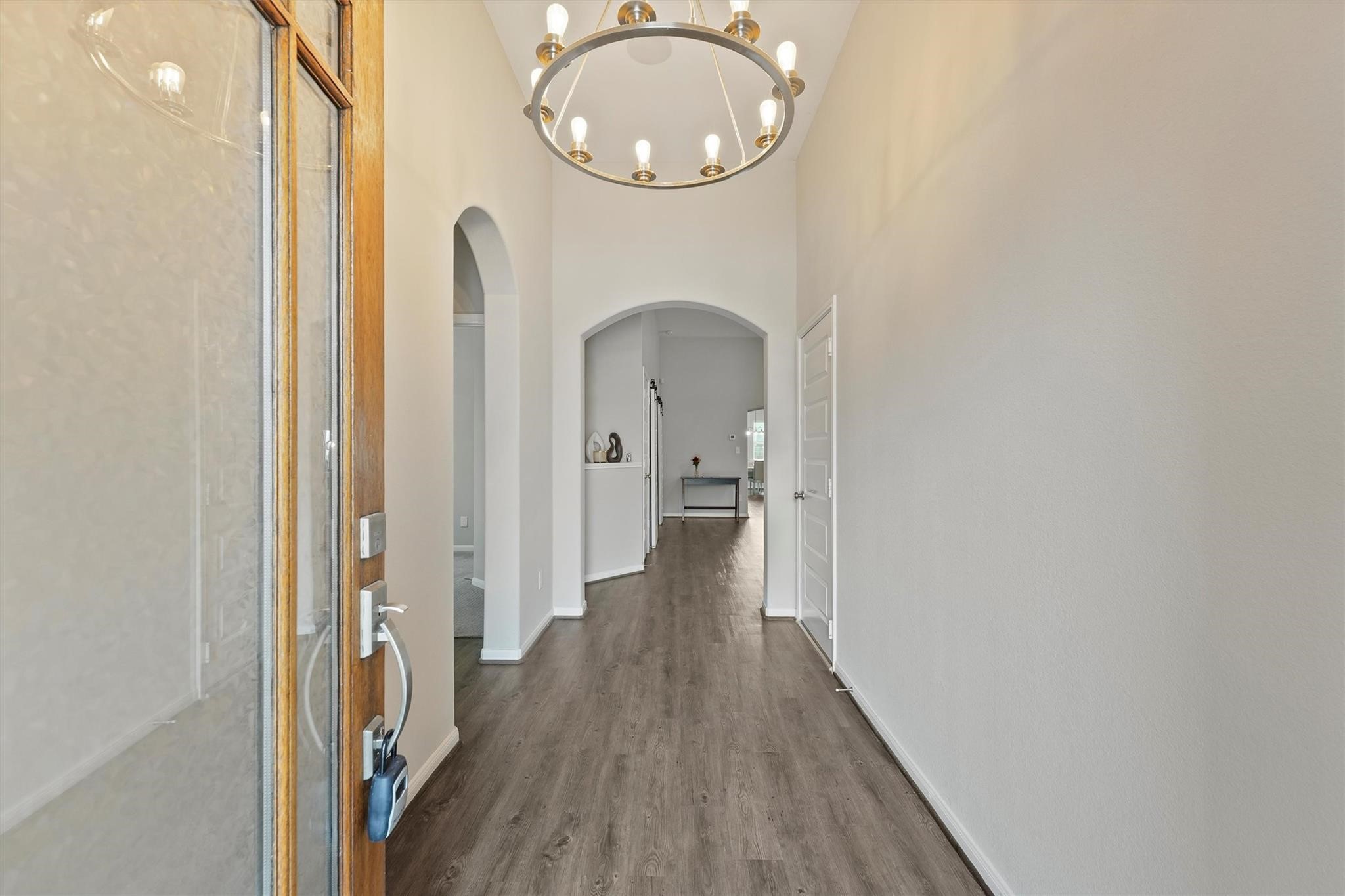15103 Dry Ridge Court Humble, TX 77346 - Photo 3 of 28 a view of a hallway with wooden floor and a bathroom