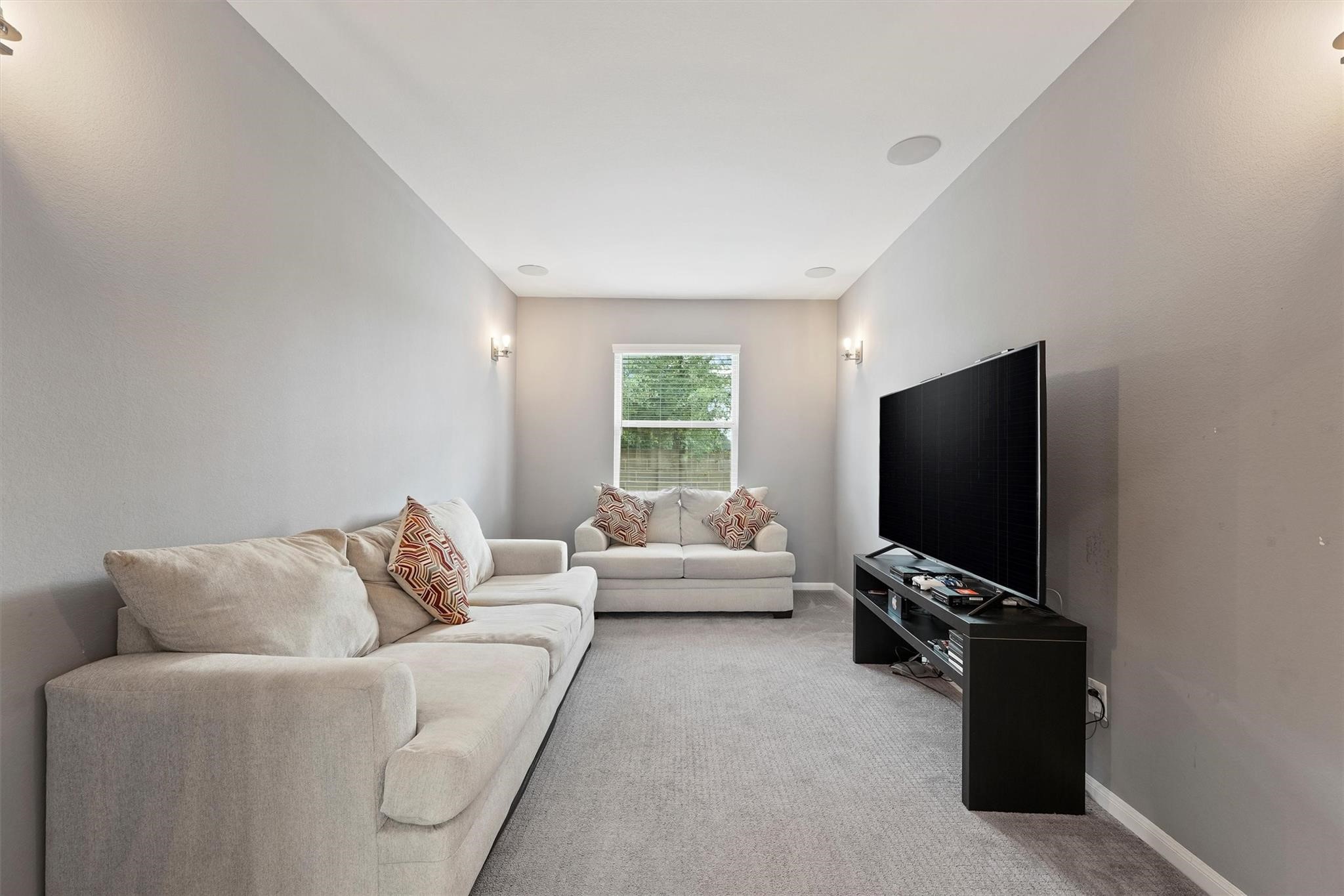 15103 Dry Ridge Court Humble, TX 77346 - Photo 6 of 28 a living room with furniture and a flat screen tv