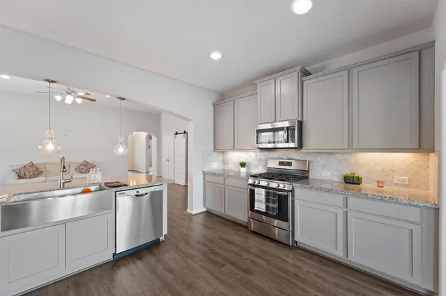 a kitchen with appliances cabinets and a sink