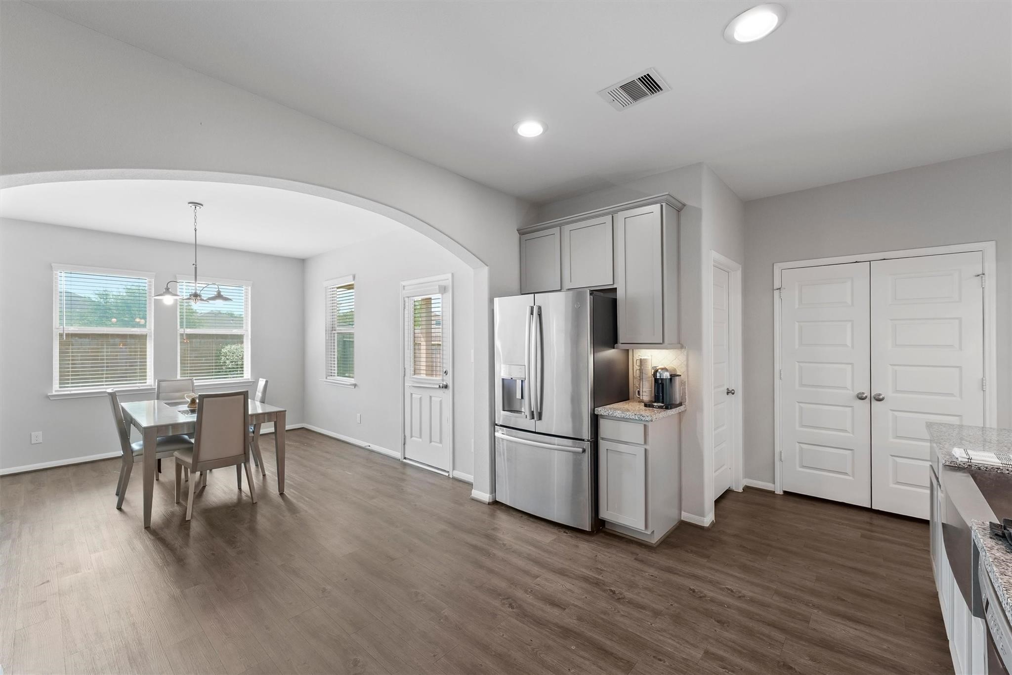 15103 Dry Ridge Court Humble, TX 77346 - Photo 10 of 28 a kitchen with stainless steel appliances a refrigerator and wooden floor