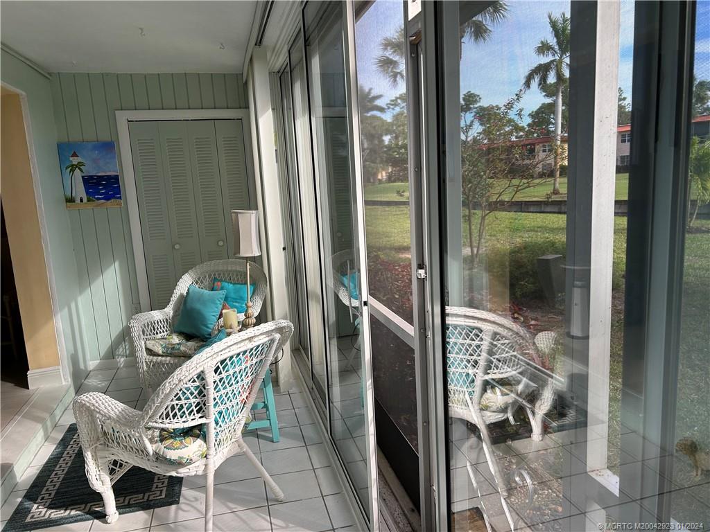 1995 Southwest Palm City Road, Unit D 47 Stuart, FL 34994 - Photo 14 of 46 Glass enclosed screen porch