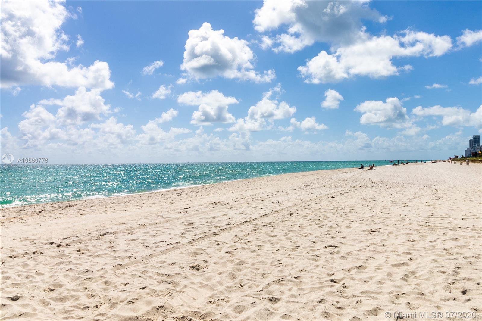8777 Collins Avenue, Unit 611 Surfside, FL 33154 - Photo 20 of 22 a view of a beach with a yard